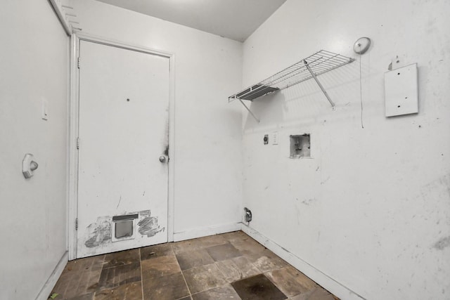 washroom featuring laundry area, baseboards, stone finish floor, hookup for a washing machine, and electric dryer hookup