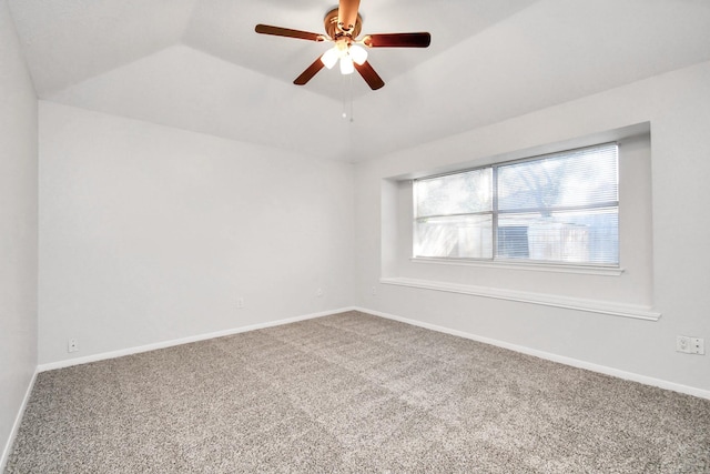 carpeted empty room with lofted ceiling, ceiling fan, and baseboards