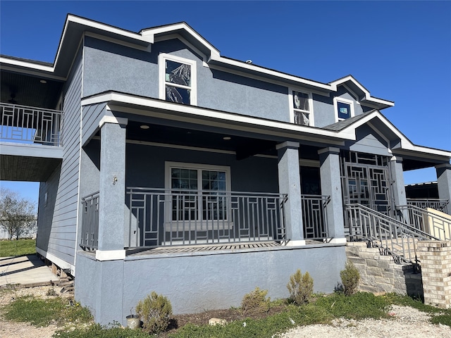 view of front of house with covered porch and stucco siding