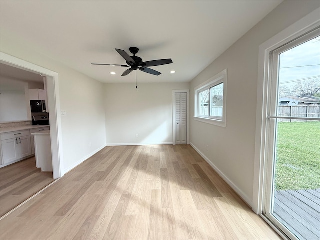 unfurnished room with light wood-type flooring, ceiling fan, baseboards, and recessed lighting