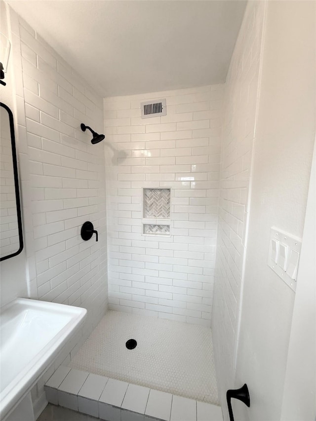 full bath with a stall shower and visible vents