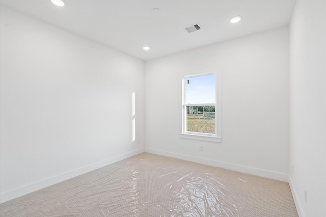 empty room with baseboards, visible vents, and recessed lighting