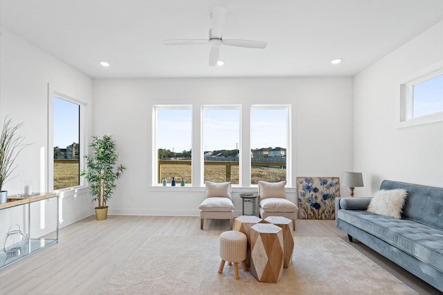 living room with baseboards, a ceiling fan, wood finished floors, and recessed lighting