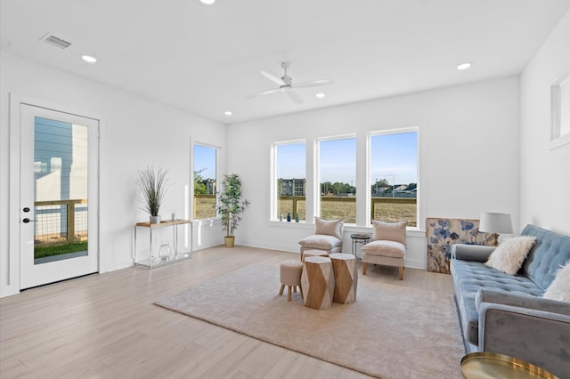 living room with ceiling fan, visible vents, wood finished floors, and recessed lighting