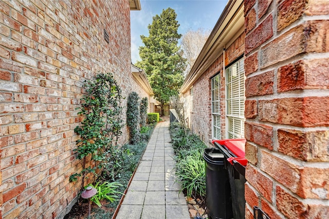 view of side of property with brick siding