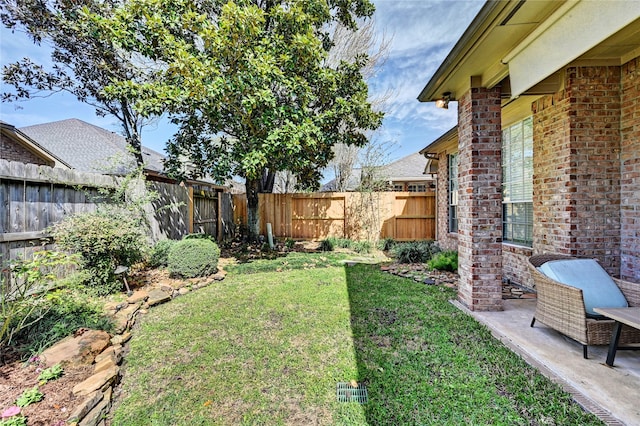 view of yard with a fenced backyard and a patio