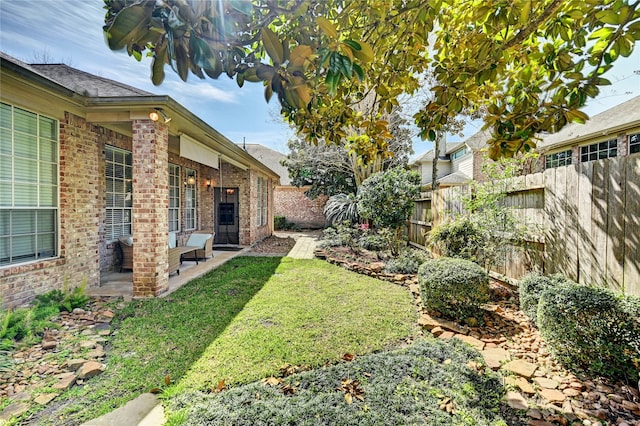 view of yard featuring a patio area and a fenced backyard