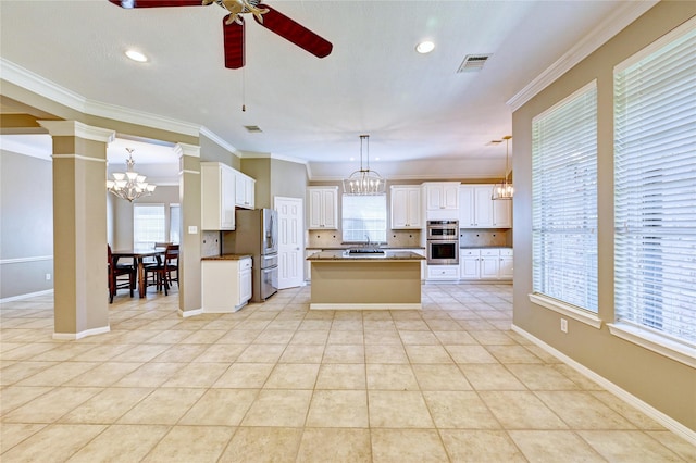 kitchen featuring decorative columns, light tile patterned floors, visible vents, appliances with stainless steel finishes, and ceiling fan with notable chandelier