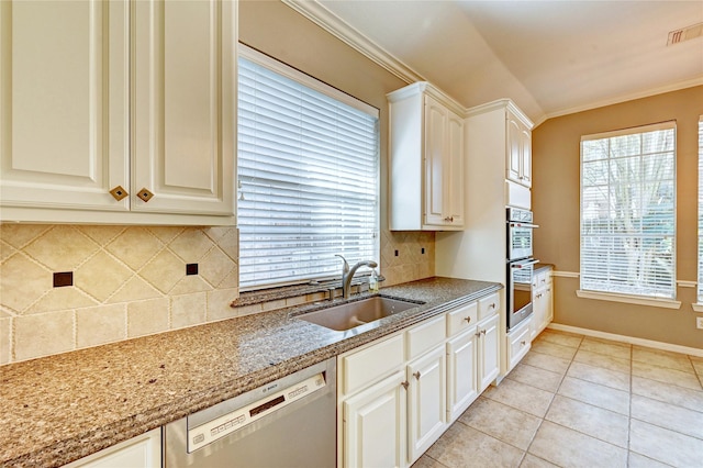 kitchen featuring light tile patterned floors, a sink, visible vents, ornamental molding, and appliances with stainless steel finishes