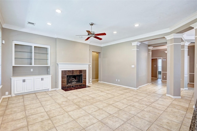 unfurnished living room featuring a tile fireplace, decorative columns, baseboards, and ceiling fan