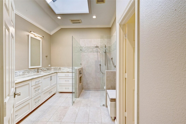 bathroom with tile patterned floors, crown molding, vanity, and a walk in shower