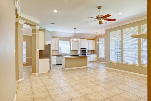 kitchen with stainless steel appliances, tasteful backsplash, white cabinetry, ceiling fan, and a kitchen island