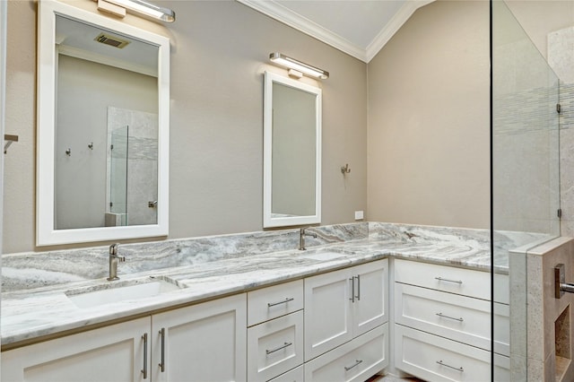 bathroom with a sink, visible vents, ornamental molding, tiled shower, and double vanity