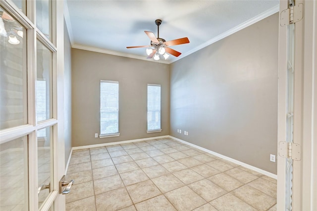 empty room with ornamental molding, tile patterned flooring, a ceiling fan, and baseboards