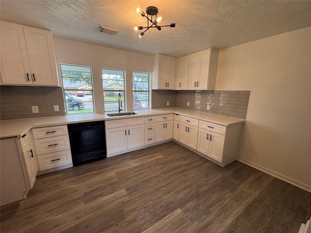 kitchen featuring black dishwasher, visible vents, dark wood finished floors, and a sink