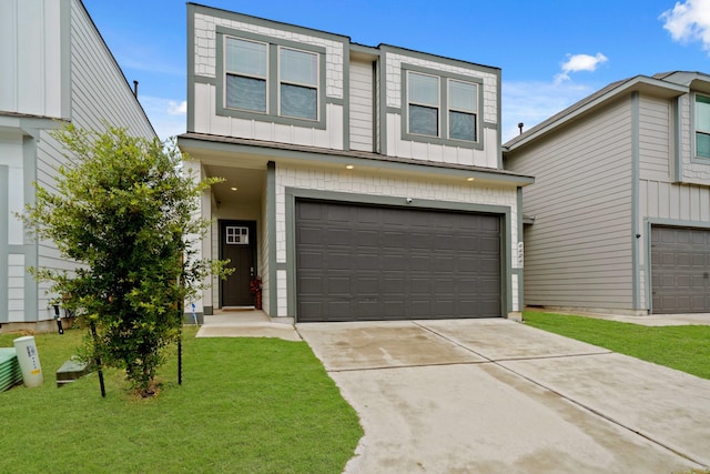 view of front of home with board and batten siding, an attached garage, driveway, and a front lawn