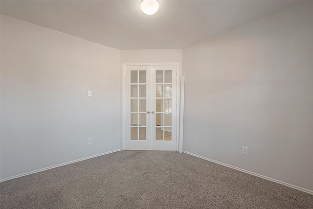 empty room with french doors, carpet, and baseboards