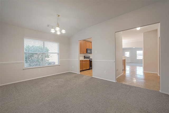 interior space featuring vaulted ceiling, baseboards, visible vents, and a notable chandelier