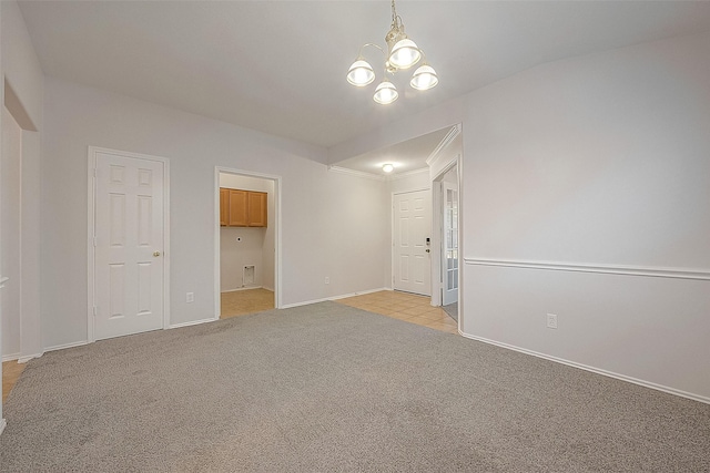 empty room featuring an inviting chandelier, baseboards, and light colored carpet