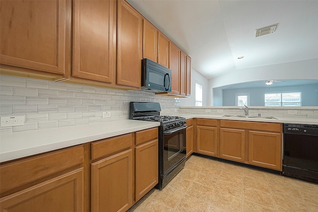 kitchen featuring light countertops, visible vents, decorative backsplash, a sink, and black appliances