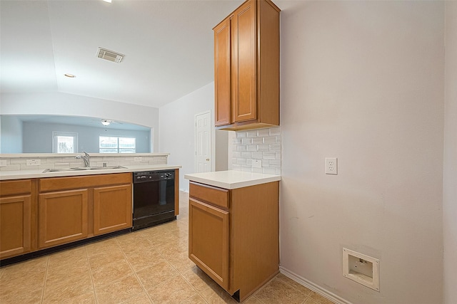 kitchen with visible vents, dishwasher, backsplash, light countertops, and a sink