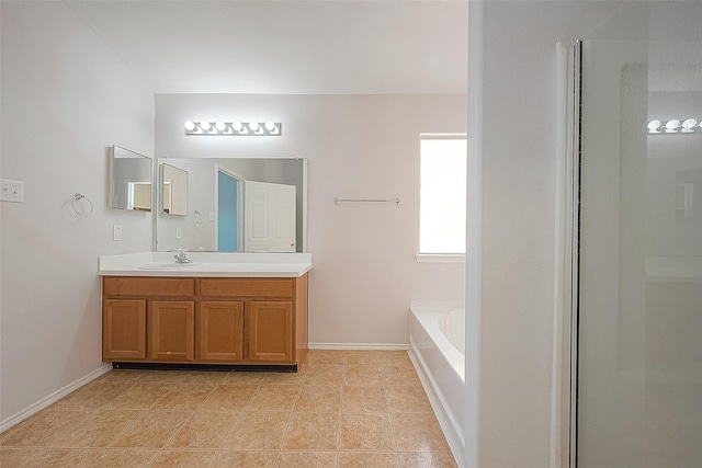 full bathroom featuring tile patterned flooring, a garden tub, vanity, and baseboards