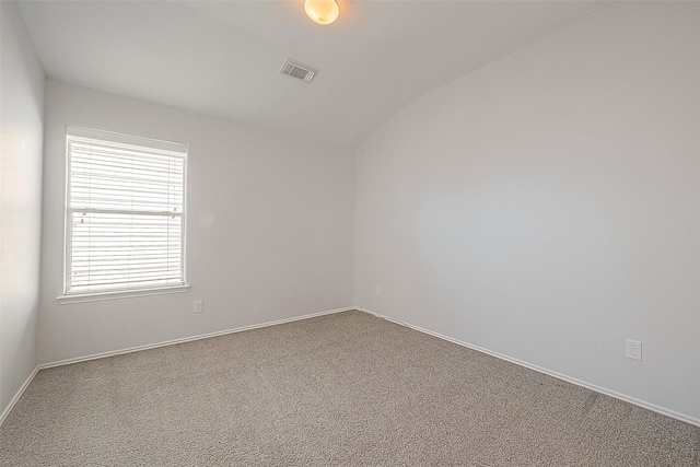 unfurnished room with lofted ceiling, baseboards, visible vents, and carpet flooring