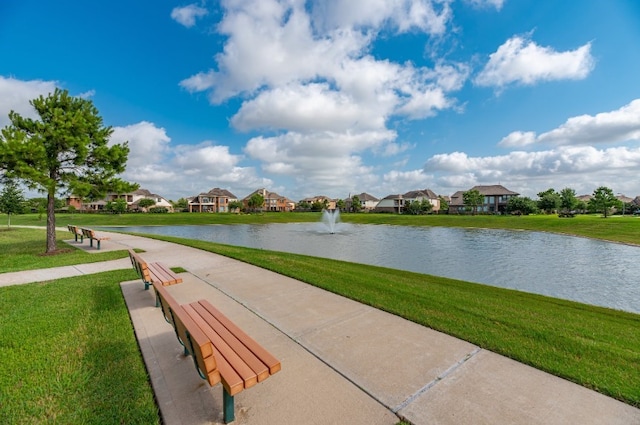 surrounding community featuring a water view, a residential view, and a yard