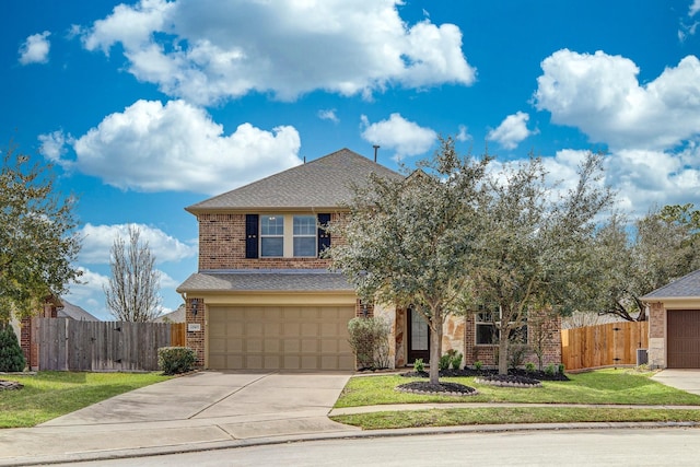 view of front of house with a front yard, fence, concrete driveway, a garage, and brick siding