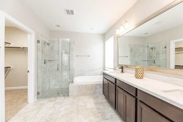 bathroom featuring visible vents, a stall shower, a sink, double vanity, and a bath