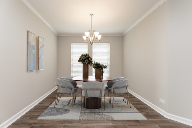 dining room with a chandelier, crown molding, baseboards, and wood tiled floor