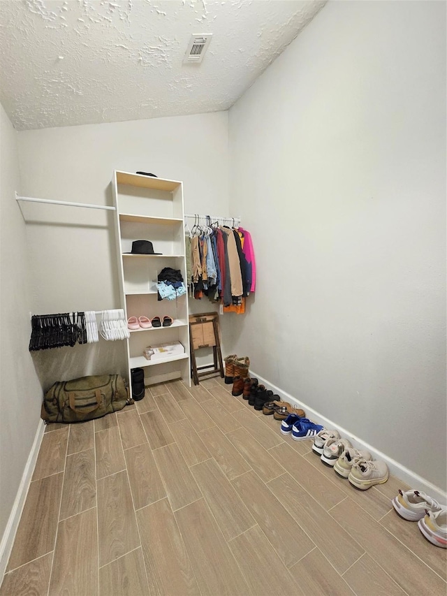 walk in closet with visible vents and wood tiled floor