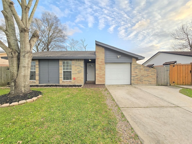 mid-century inspired home with a garage, brick siding, a front yard, and fence