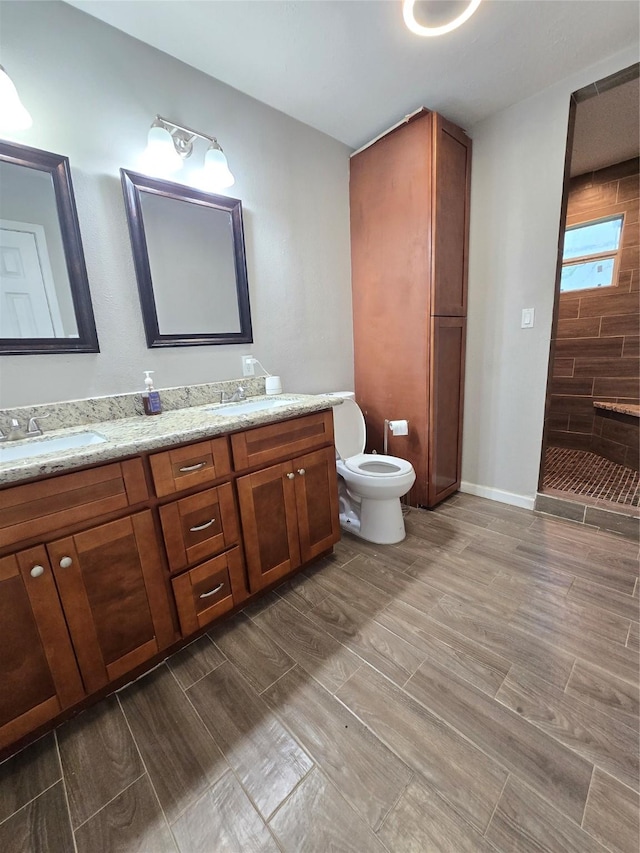 full bathroom featuring vanity, tiled shower, and wood finish floors