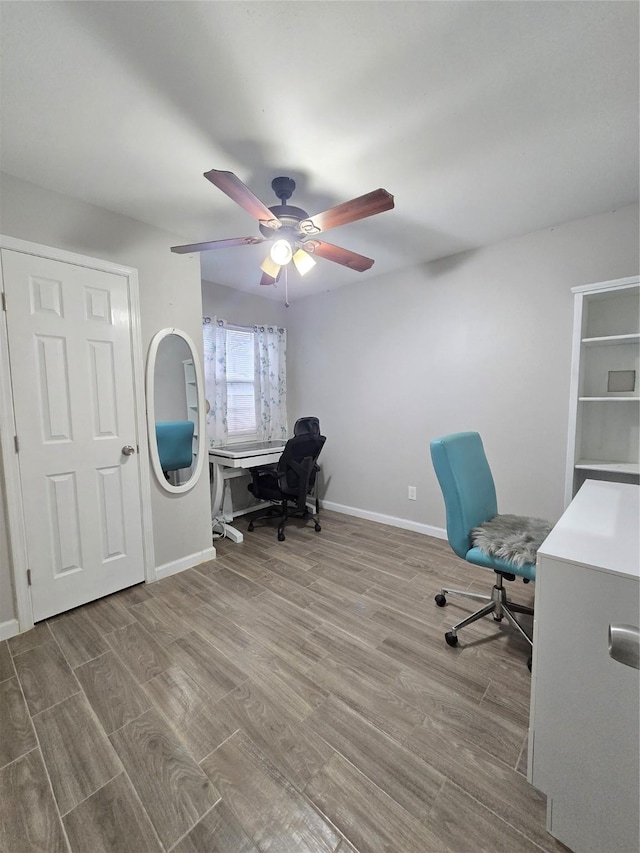 office area featuring ceiling fan, baseboards, and wood finished floors