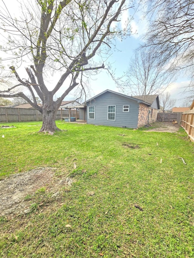 view of yard with a fenced backyard