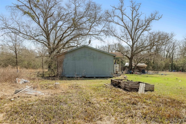 exterior space featuring an outbuilding and a lawn