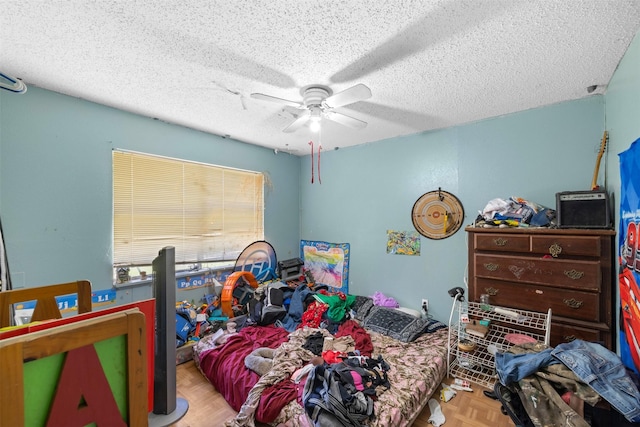 bedroom with ceiling fan and a textured ceiling