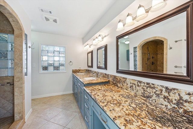 full bathroom with a walk in shower, tile patterned flooring, visible vents, vanity, and baseboards