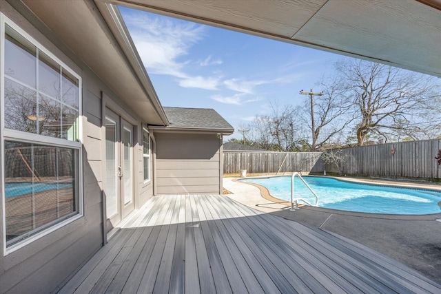 view of swimming pool featuring a deck, a fenced backyard, and a fenced in pool