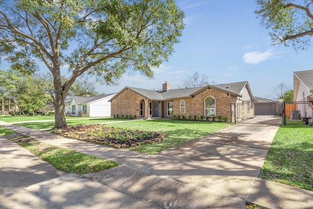 ranch-style home with brick siding, a chimney, a gate, driveway, and a front lawn