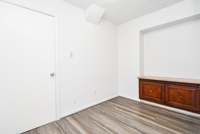 unfurnished room featuring baseboards and wood finished floors