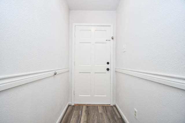 entryway with dark wood-style floors and baseboards