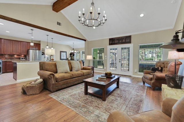 living room featuring beam ceiling, a notable chandelier, visible vents, light wood-style floors, and high vaulted ceiling