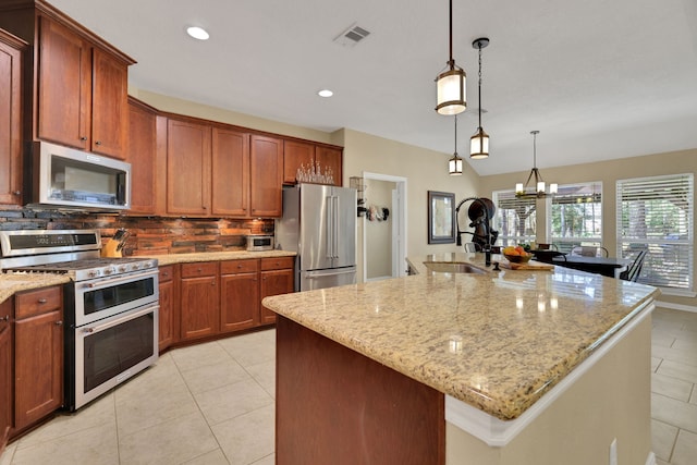 kitchen with visible vents, decorative backsplash, appliances with stainless steel finishes, light tile patterned flooring, and a sink