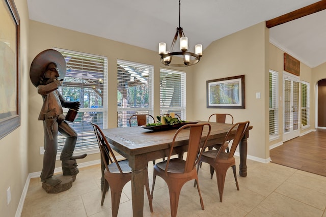 dining space featuring light tile patterned flooring, vaulted ceiling, baseboards, and an inviting chandelier