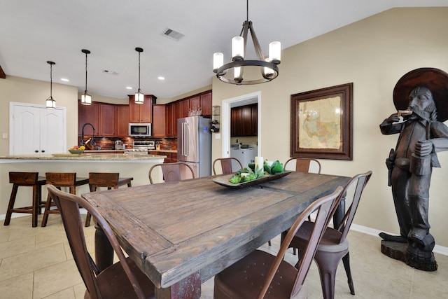 dining space with light tile patterned floors, visible vents, baseboards, washing machine and dryer, and recessed lighting