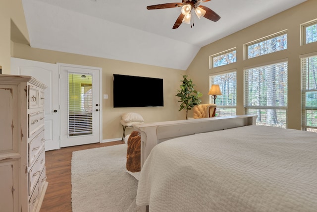 bedroom with dark wood-type flooring, vaulted ceiling, baseboards, and a ceiling fan