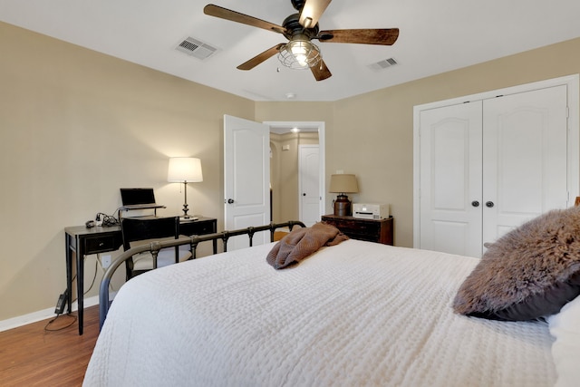 bedroom with a closet, visible vents, and baseboards