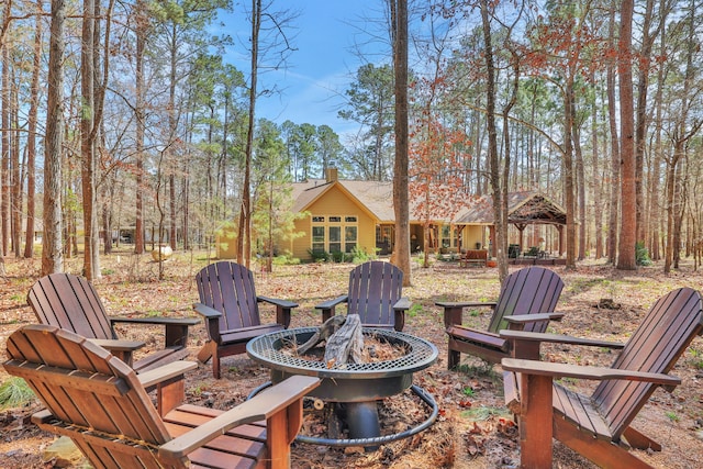 view of yard featuring an outdoor fire pit and a gazebo